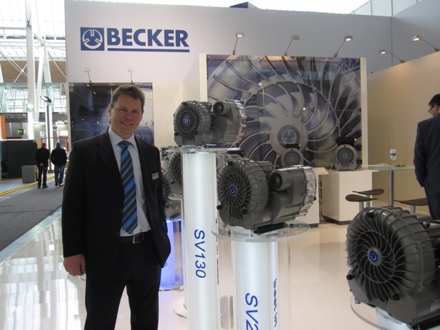 Stefan Beierlein, from Becker, next to their new line of SV side channel blowers.